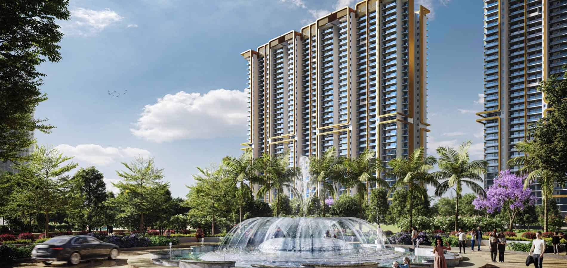 A grand decorative water fountain in a landscaped courtyard with palm trees and a luxury high-rise residential building in the background