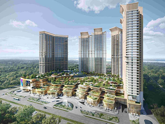 Aerial view of a modern luxury high-rise residential complex with a sprawling green podium and commercial spaces