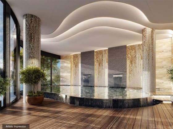 Luxurious indoor swimming pool with an elegant curved ceiling, golden mosaic pillars, and wooden decking