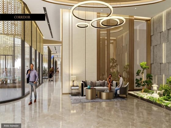 Elegant building corridor lounge with high ceilings, modern circular ring chandeliers, and a small indoor Zen garden